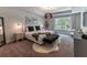 This beautiful main bedroom features a tray ceiling, modern lighting, and a large window at 842 Bridgewater Sw St, Atlanta, GA 30310