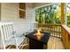 Relaxing covered patio with rocking chairs and fire pit, perfect for outdoor gatherings at 842 Bridgewater Sw St, Atlanta, GA 30310