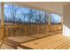 Large outdoor deck with wood flooring and railings overlooking the backyard and wooded area at 2023 Fern Mountain Ln, Marietta, GA 30064