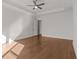 Spacious bedroom with hardwood floors, a ceiling fan, a tray ceiling, and a door to the closet at 2023 Fern Mountain Ln, Marietta, GA 30064