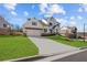 Lovely two-story home featuring a three car garage, and manicured yard at 2023 Fern Mountain Ln, Marietta, GA 30064