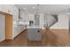 Open concept kitchen features white cabinets, stainless steel appliances, a center island, and hardwood floors at 2023 Fern Mountain Ln, Marietta, GA 30064