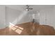 Open-concept living room with hardwood floors, neutral walls, and a modern ceiling fan at 2023 Fern Mountain Ln, Marietta, GA 30064