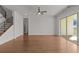 Spacious living room with hardwood floors, ceiling fan, stairs, and sliding glass doors to the outdoor deck at 2023 Fern Mountain Ln, Marietta, GA 30064