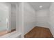 Spacious walk-in closet with ample shelving and stylish wood-look floors at 2023 Fern Mountain Ln, Marietta, GA 30064
