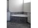 Bathroom showcasing a luxurious tub with tile surround and dual vanities at 2925 Coach River Way, Cumming, GA 30040