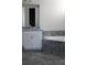 Bathroom featuring a bathtub with tile surround and granite topped vanity at 2925 Coach River Way, Cumming, GA 30040