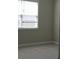 This bedroom has neutral walls, carpet flooring and a bright window with blinds, creating a cozy space at 2925 Coach River Way, Cumming, GA 30040