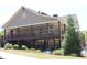 Two-story clubhouse with a wraparound porch and well-maintained lawn at 2925 Coach River Way, Cumming, GA 30040