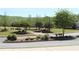 A beautifully landscaped community common area with sidewalks and mature trees at 2925 Coach River Way, Cumming, GA 30040