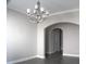 Elegant dining area featuring stylish chandelier and arched doorway, great for entertaining at 2925 Coach River Way, Cumming, GA 30040