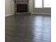 Cozy living area showcasing a stone fireplace and hardwood floors, perfect for relaxing evenings at 2925 Coach River Way, Cumming, GA 30040