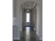 Bright hallway with arched doorways and dark wood flooring, leading to outdoor space at 2925 Coach River Way, Cumming, GA 30040