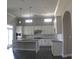 Modern kitchen featuring white cabinets, granite countertops, stainless steel appliances and stylish pendant lighting at 2925 Coach River Way, Cumming, GA 30040