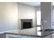 Open kitchen view with granite countertops, a stainless steel sink, and a glimpse of the living room fireplace at 2925 Coach River Way, Cumming, GA 30040