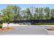 Several well-maintained tennis courts are lined by trees and benches at 2925 Coach River Way, Cumming, GA 30040
