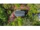 An aerial view showcases the home's backyard, featuring a patio, mature trees and lush greenery, and a fire pit at 297 Breeze Hill Ln, Canton, GA 30114