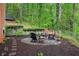 Cozy backyard featuring a fire pit surrounded by Adirondack chairs at 297 Breeze Hill Ln, Canton, GA 30114