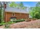 Brick house backyard featuring a lush green lawn, trees, and raised garden beds with a pea gravel walkway at 297 Breeze Hill Ln, Canton, GA 30114