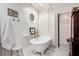Elegant bathroom with a clawfoot tub, vintage fixtures, and herringbone tile floor at 297 Breeze Hill Ln, Canton, GA 30114