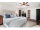 Bright bedroom featuring a ceiling fan, hardwood floors, and refined white walls at 297 Breeze Hill Ln, Canton, GA 30114