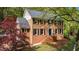 Charming brick home with a lush front yard featuring a brick facade, symmetrical design, and mature landscaping at 297 Breeze Hill Ln, Canton, GA 30114