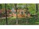 Charming brick home with a lush front yard and mature trees, offering a sense of privacy and curb appeal at 297 Breeze Hill Ln, Canton, GA 30114