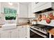 Updated kitchen showcasing a farmhouse sink, stainless steel oven, and butcher block counters at 297 Breeze Hill Ln, Canton, GA 30114
