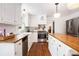 Bright kitchen with butcher block counters, white cabinetry, and stainless steel appliances at 297 Breeze Hill Ln, Canton, GA 30114