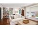 Bright living room with built-in bookshelves, comfortable sofa, and bay windows at 297 Breeze Hill Ln, Canton, GA 30114