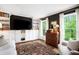 Cozy living room features built-in shelving, large windows, and hardwood floors at 297 Breeze Hill Ln, Canton, GA 30114