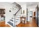 Staircase with Gathering photos on display, hardwood floors and neutral paint at 297 Breeze Hill Ln, Canton, GA 30114