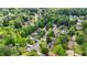 An aerial view showcases this neighborhood featuring lush tree cover, sidewalks and well-maintained homes at 3925 Chicamauga Ne Dr, Kennesaw, GA 30144