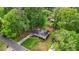 An aerial view of a well-maintained single-Gathering home surrounded by lush trees and landscaping at 3925 Chicamauga Ne Dr, Kennesaw, GA 30144