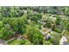An aerial view shows lush trees with homes nestled below in a thriving neighborhood at 3925 Chicamauga Ne Dr, Kennesaw, GA 30144