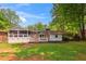 A well-maintained backyard featuring a deck, screened porch, and a lush lawn at 3925 Chicamauga Ne Dr, Kennesaw, GA 30144