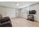 Finished basement with wood-look flooring, seating, and a mounted television at 3925 Chicamauga Ne Dr, Kennesaw, GA 30144
