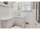 Bright bathroom showcasing a white toilet, vanity, and tiled walls at 3925 Chicamauga Ne Dr, Kennesaw, GA 30144