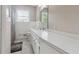 Bright bathroom featuring a white vanity with integrated sink and a window at 3925 Chicamauga Ne Dr, Kennesaw, GA 30144