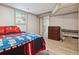 Well-lit bedroom with a closet, wood-look floors, and a view to the backyard through a window at 3925 Chicamauga Ne Dr, Kennesaw, GA 30144