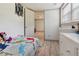 Bright bedroom with modern wood-look floors, a built-in dresser, and a view to the outside at 3925 Chicamauga Ne Dr, Kennesaw, GA 30144