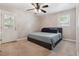 A neutral bedroom showcasing a queen bed, window, and ceiling fan at 3925 Chicamauga Ne Dr, Kennesaw, GA 30144