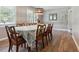 Elegant dining room with wood floors, decorative chandelier, and charming wall details at 3925 Chicamauga Ne Dr, Kennesaw, GA 30144