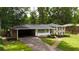 Lovely two-story house featuring an attached carport and manicured landscaping at 3925 Chicamauga Ne Dr, Kennesaw, GA 30144