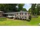 Two-story brick home with front porch, black shutters, and mature trees at 3925 Chicamauga Ne Dr, Kennesaw, GA 30144