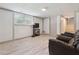 Cozy living room featuring wood-look floors, ample natural light, and stairs to the upper level at 3925 Chicamauga Ne Dr, Kennesaw, GA 30144