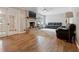 Cozy living room with brick fireplace, hardwood floors, and comfortable seating area at 3925 Chicamauga Ne Dr, Kennesaw, GA 30144