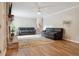 Bright living room with hardwood flooring, brick fireplace, comfortable couches, and staircase access at 3925 Chicamauga Ne Dr, Kennesaw, GA 30144