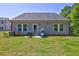 Backyard featuring a small patio, table, grill, and ample green space at 1014 Starmoss Ln, Conyers, GA 30094
