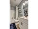 Cozy bathroom featuring a tub with shower, decorative shelves, and a stylish vanity with sink and fixtures at 1014 Starmoss Ln, Conyers, GA 30094